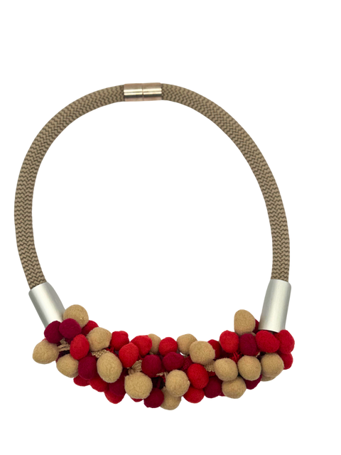 A necklace with a metallic chain and pom-pom details, primarily in red and gold colors.