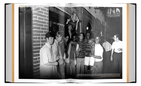 Open book showing a black and white photograph of a group of people in an urban setting.