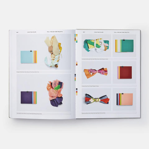 Open book displaying colorful accessories on a white background