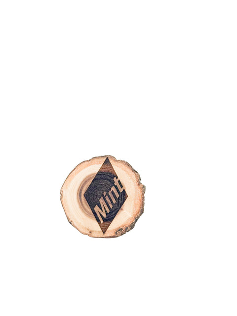 A circular wooden magnet with the word 'Mint' inscribed on it.