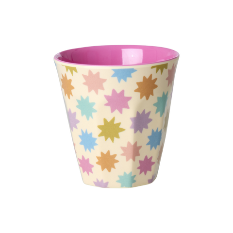 Colorful star-patterned cup with pink interior on a white background