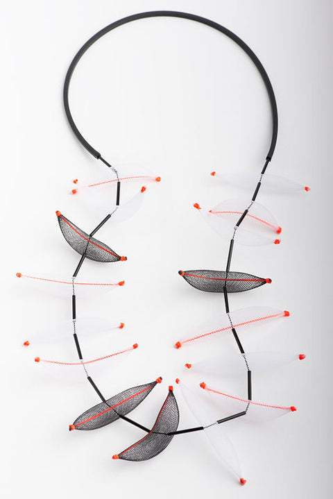 Long necklace made of colorful pieces of nets, tulles, and rubber.