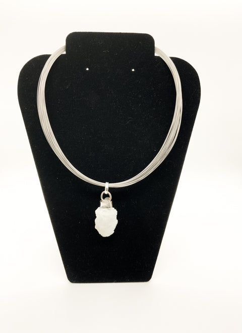 A sterling silver wire chain necklace with a labradorite stone pendant, displayed on a black mannequin bust.