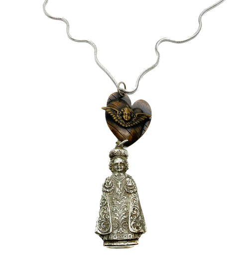 Angel pendant in a heart with a priest