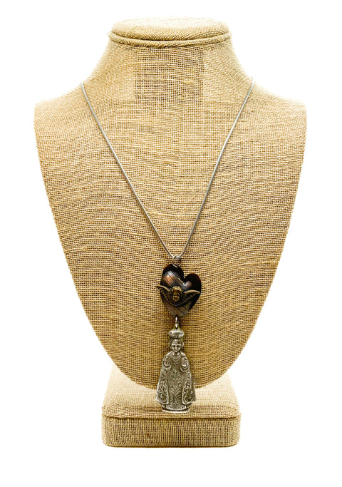 Angel pendant in a heart with a priest