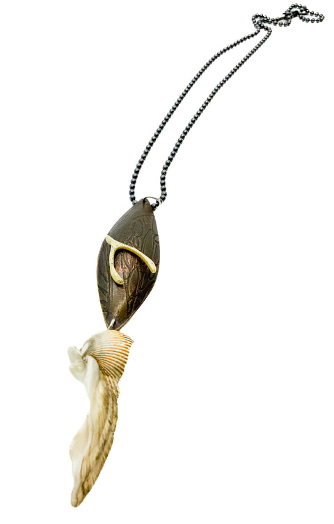 A wishbone pendant necklace displayed on a mannequin bust. The pendant is made of wood with a bone wishbone detail, and different objects, and the necklace chain is black.