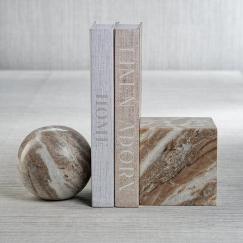 Marble bookend in two different shapes, a ball and a square with two books in the middle. 