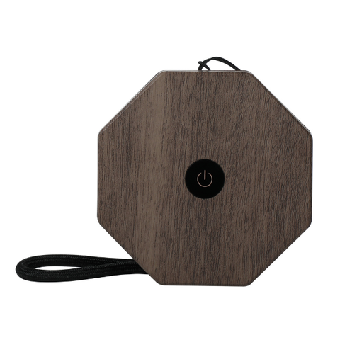 Wooden octagonal device with power button on a white background