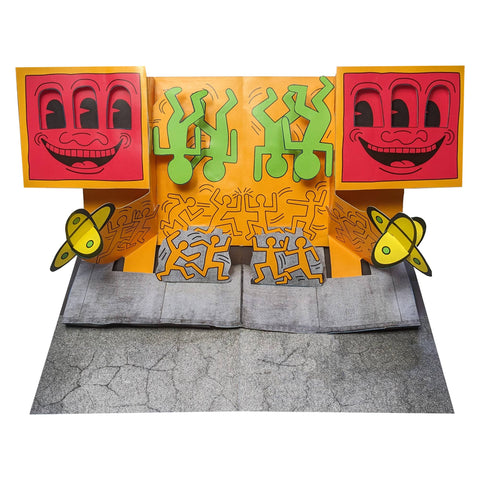 Pop-up art piece with colorful characters and faces on a white background