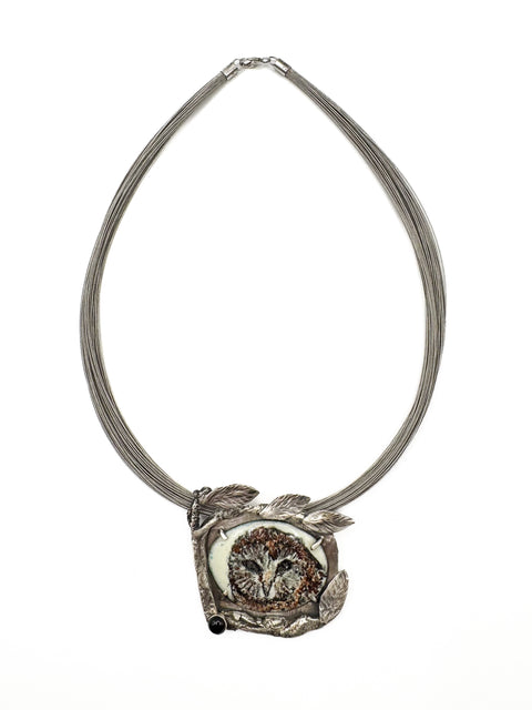 Necklace with an owl pendant on a white background