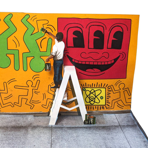 Person painting a colorful mural with abstract designs on a wall.