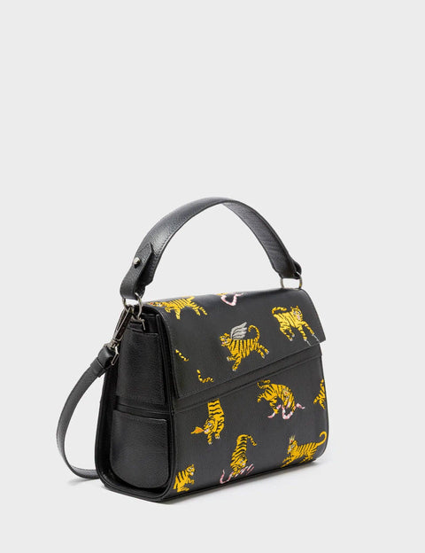 Black handbag with yellow tiger pattern on a light gray background
