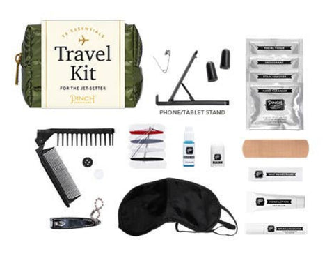 Travel kit with various travel essentials on a white background