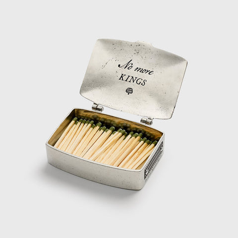 Matches in a silver box with 'No more KINGS' text on a light gray background