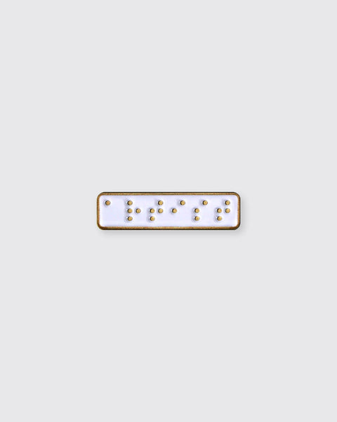 Rectangular enamel pin with gold accents on a white background