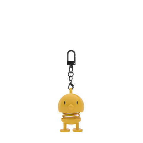 Yellow character keychain with a spring-like design on a white background