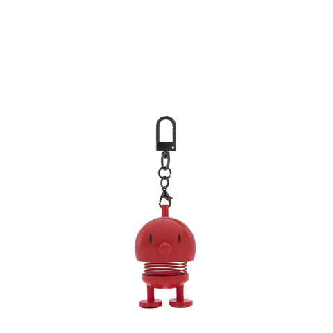 Red character keychain with a spring mechanism on a white background