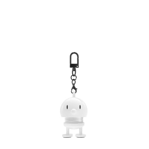 White character keychain with a black clip on a white background