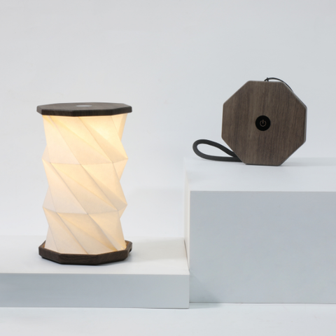 Twisted cylindrical lamp on a light gray background