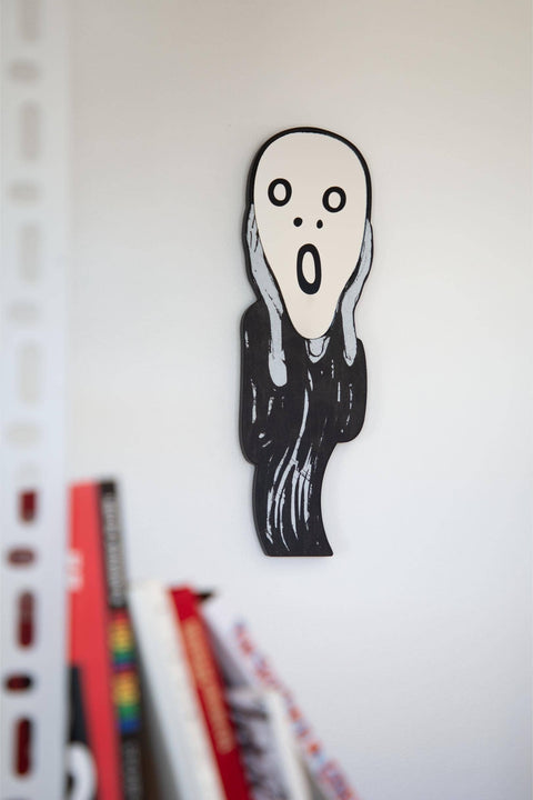 Black and white illustration of "The Scream" with a surprised expression on a white background with books in front.