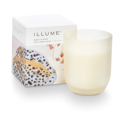 Illume candle with packaging on a white background