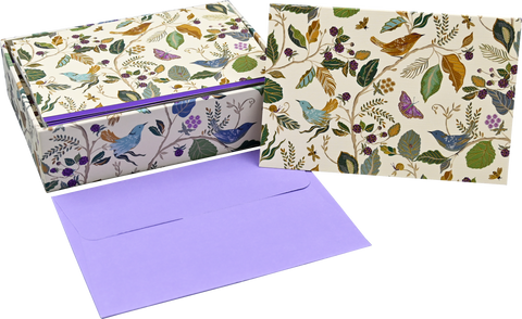 Set of stationery items with floral and bird pattern on a white background