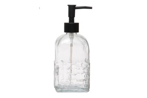 Clear glass bottle with black pump dispenser on a white background