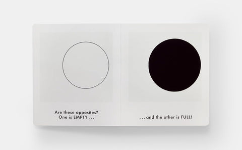 Book with two circles, one black and one white, on a white background.