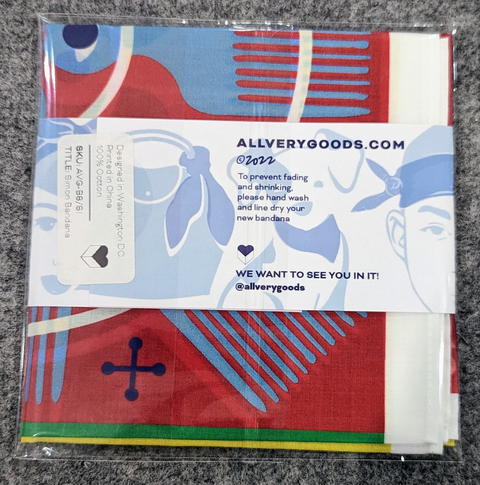 Packaged bandana with colorful design and branding information on a gray surface