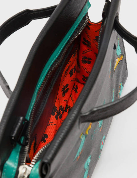 Close-up of a handbag with a colorful interior lining.