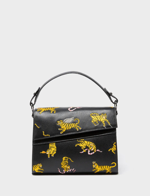Black handbag with yellow tiger patterns on a light gray background