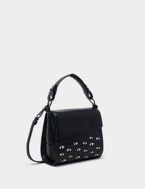 Black handbag with eyelets on a light gray background