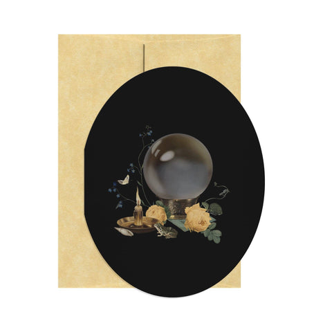 Decorative card with a black circle featuring a crystal ball and flowers on a beige border.