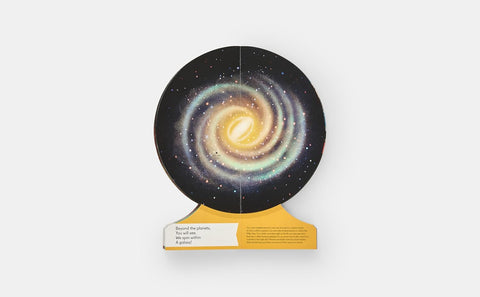 Model of a galaxy on a stand with a white background