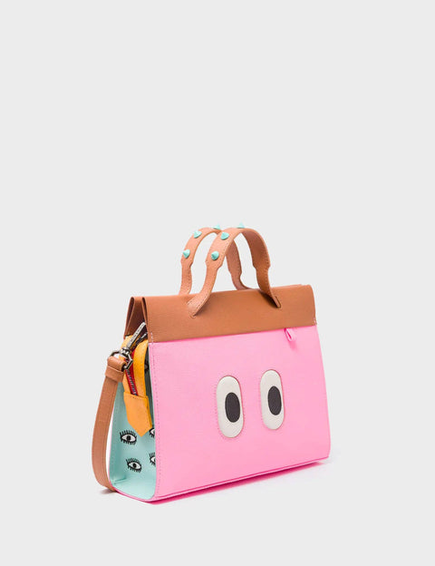 Pink handbag with cartoon eyes design on a light gray background