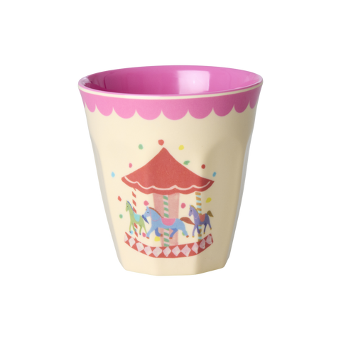 Children's cup with pink top and carousel design on a white background
