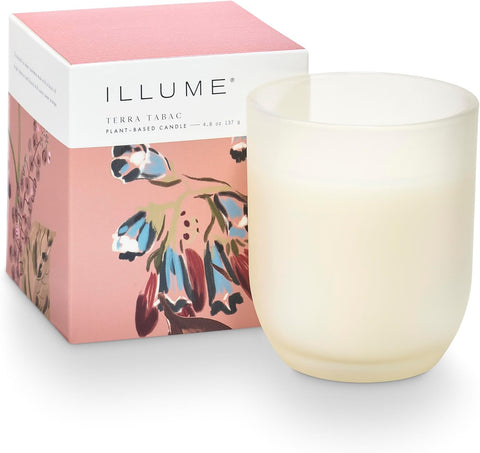 Illume candle with floral packaging on a white background