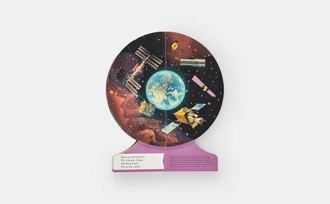 Educational book of space with planets and satellites on a stand against a white background