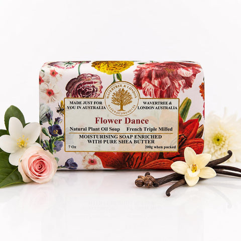 Flower Dance soap bar with floral packaging and vanilla beans on a white background