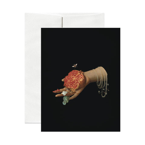 Greeting card with a hand holding fruit on a black background