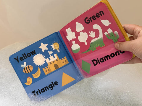 Colorful children's book open to pages with shapes and colors