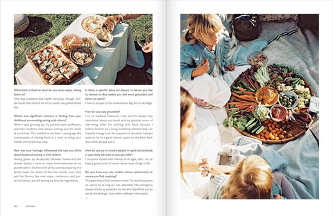Open book showing a picnic scene with food and people on a grassy area.