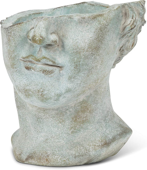 Decorative pot shaped like a face with a neutral expression on a white background
