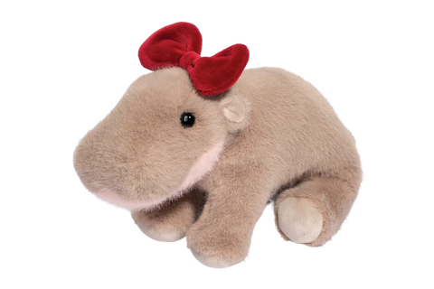 Plush toy hippo with a red bow on a white background
