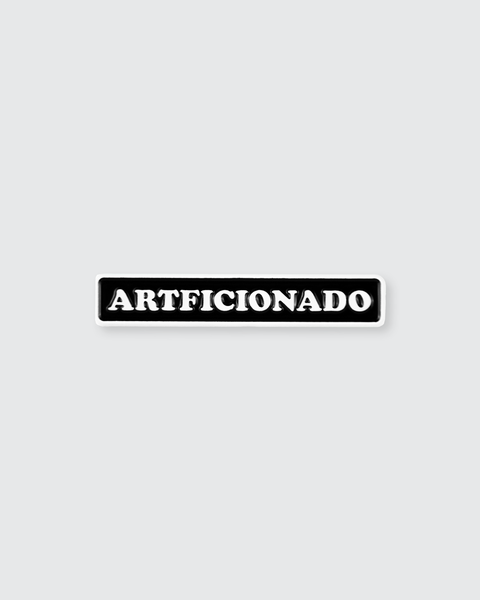 Black 'ARTFICIONADO' pin on a light gray background