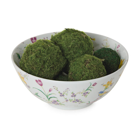 Decorative plate with floral and bird design and in the inside decorative green moss balls on a white background