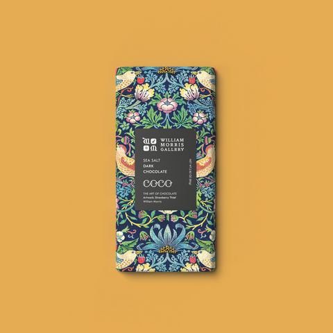 Chocolate bar with decorative packaging on a mustard yellow background