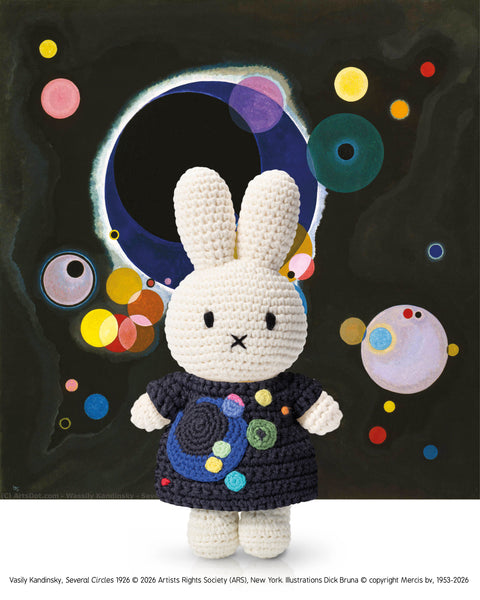 Crocheted bunny toy with a colorful abstract background