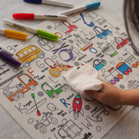 Colorful children's activity mat with markers and a hand wiping it.
