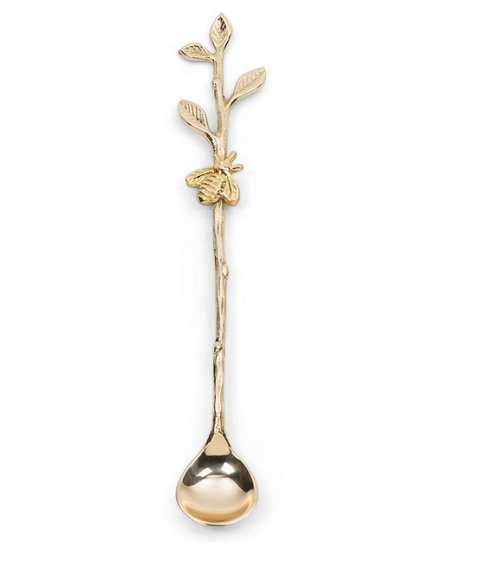 Gold spoon with decorative handle on a white background